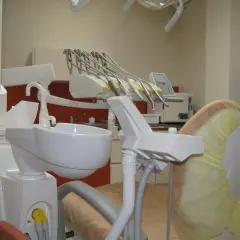 Nowoczesny gabinet stomatologiczny z fotelem dentystycznym i narzędziami.